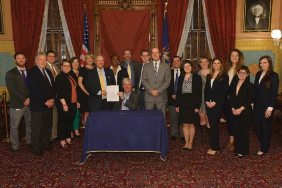 Alumnae Claire Nagel, ‘18, and Lauren Fitzsimons, ‘17, and Clinical Assistant Professor of Law Steve Gray joined Michigan Gov. Rick Snyder, ‘82, during the December 2017 bill-signing session implementing new unemployment insurance legislation.