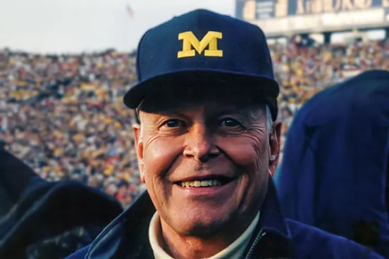 A portrait of The Hon. William “Bill” A. Clark, ’52 at a Michigan Football game.