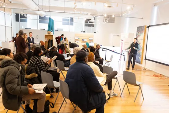 Student speaking in front of a group of people