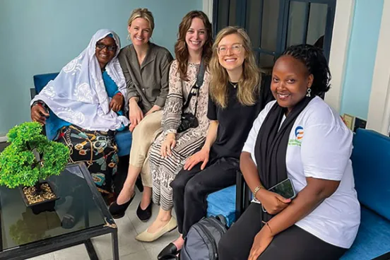 Clinic students (in the center, from left to right) Lindsey Corbett, Emily Unger, and Jessica Carter met with Nyiransenguwera Mayimuna (far left), a BioMassters client, and Benjamine Barihuta (far right), a member of the BioMassters team, on a site visit.