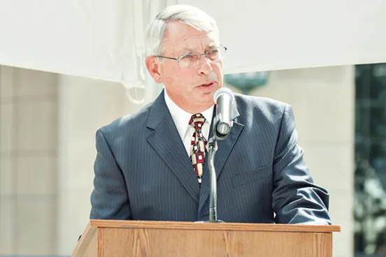 Bruce Bickner, ’68, speaks at the dedication ceremony for South Hall (now Jeffries Hall) in 2012.