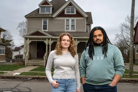 Abby Flynn and King Deas stand outside a rundown house at the center of a recent case in the Civil-Criminal Litigation Clinic.