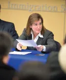 Barbara McQuade speaking in a conference room with meeting attendees