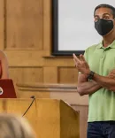 Lecturer addresses class wearing a face maks
