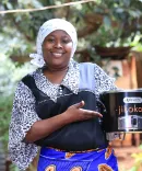 Women holding a clean cooking stove by BURN Manufacturing