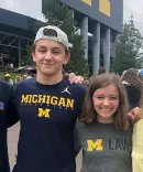 Lacey Sikora and family standing outside the stadium 