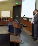 Students standing in the front of a class at a University Law School Event 
