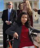 Ehlena with her dog fighting for disability rights on the steps of the Supreme Court.