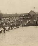 Students playing tug-of-war in a pond
