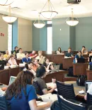 Students being lectured to and learning in the classroom at Law School 