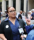 Khalilah Spencer, ’01, speaks with reporters.