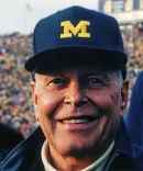 A portrait of The Hon. William “Bill” A. Clark, ’52 at a Michigan Football game.