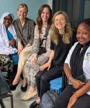 Clinic students (in the center, from left to right) Lindsey Corbett, Emily Unger, and Jessica Carter met with Nyiransenguwera Mayimuna (far left), a BioMassters client, and Benjamine Barihuta (far right), a member of the BioMassters team, on a site visit.