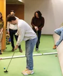 Michigan Law students playing mini golf in the Law Library subs
