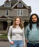 Abby Flynn and King Deas stand outside a rundown house at the center of a recent case in the Civil-Criminal Litigation Clinic.